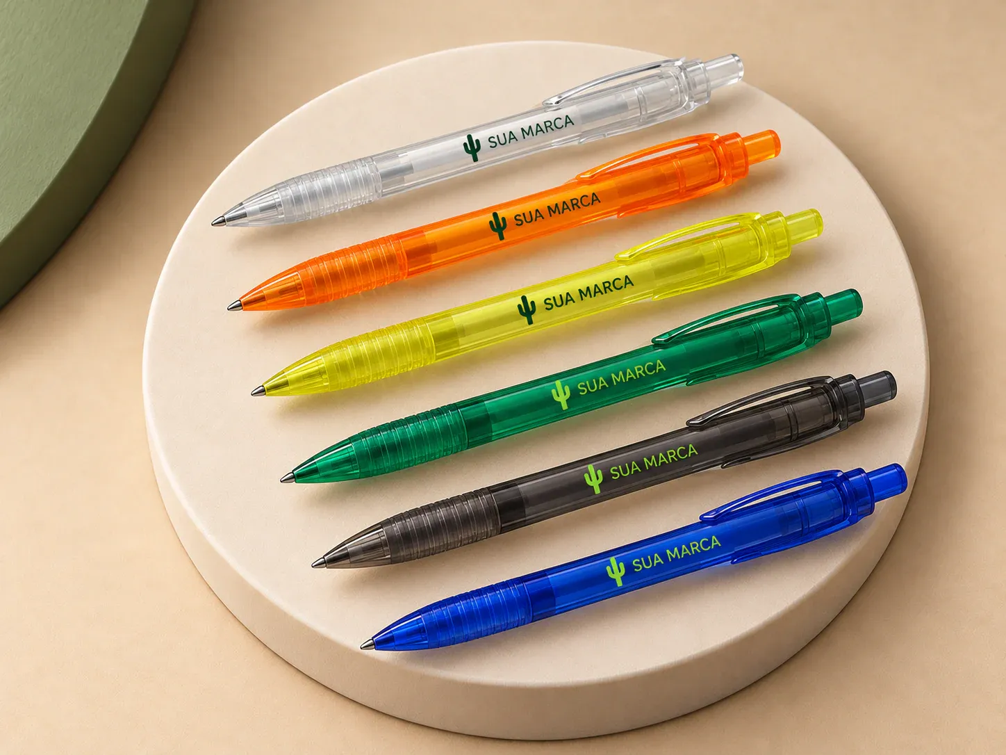 Caneta plástica translúcida, com exemplo de personalização colorida: um cacto e o texto “SUA MARCA” impressos em cor