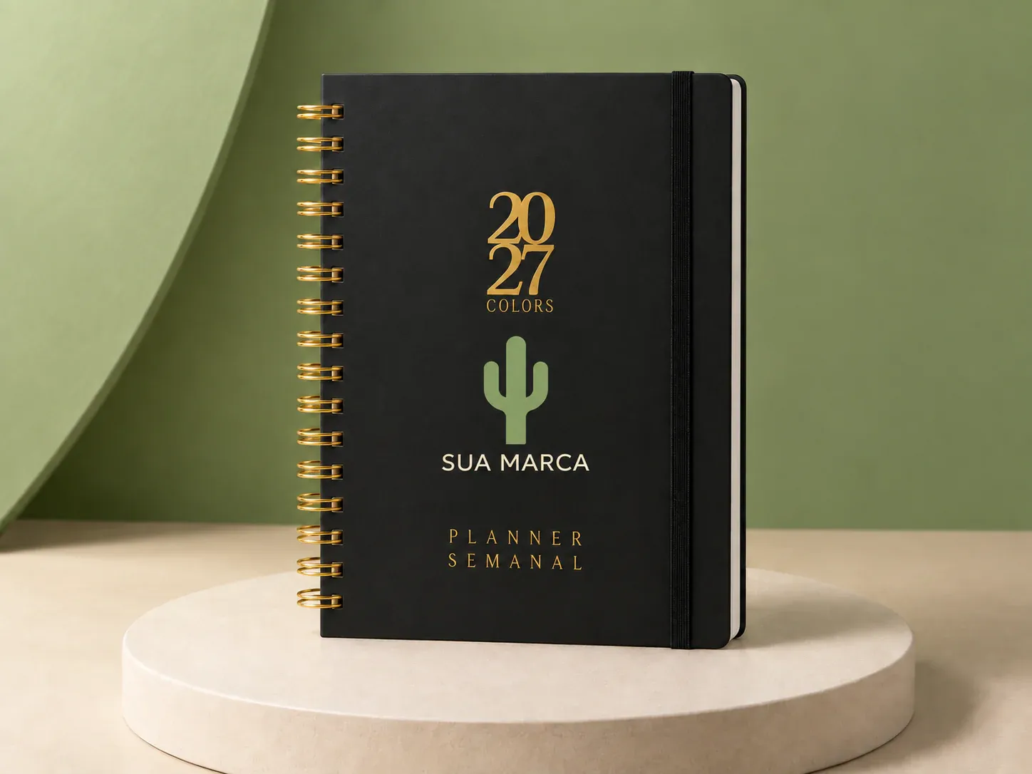 Planner semanal com espiral dourada, com exemplo de personalização colorida: um cacto e o texto “SUA MARCA” impressos em cor